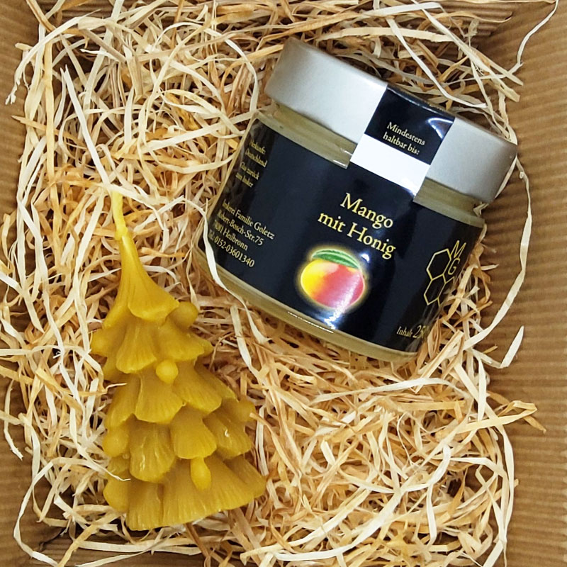 Mango in honig mit bienenwachskerze